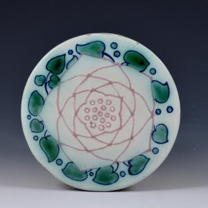 Disk depicting a stylized rose
